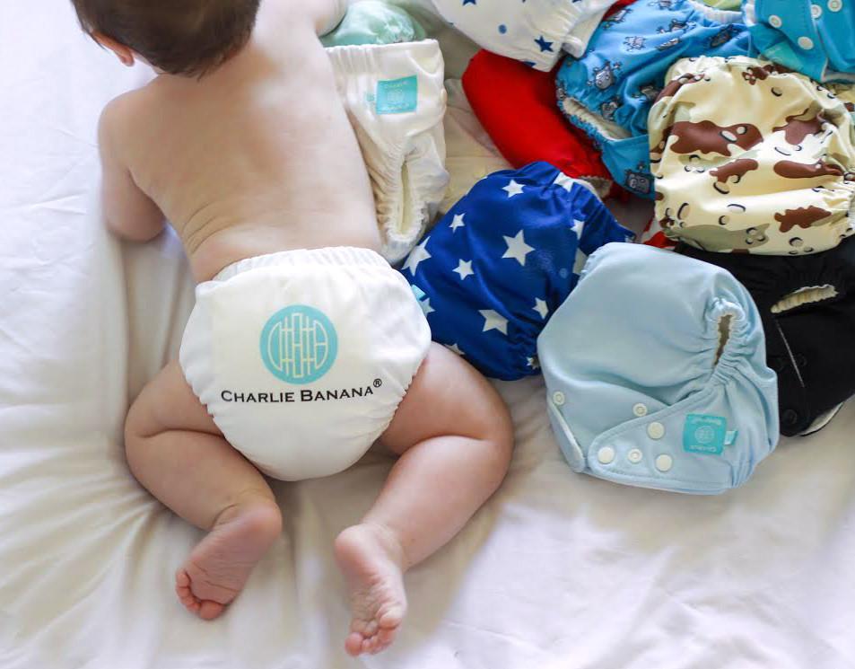 Noah crawling around his stash of Charlie Banana Reusable Cloth Diapers