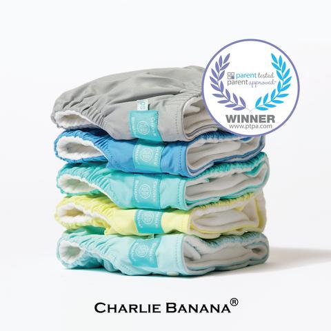A pack of 5 Charlie Banana reusable cloth diapers in solid colors. Parents tested, parents approved.