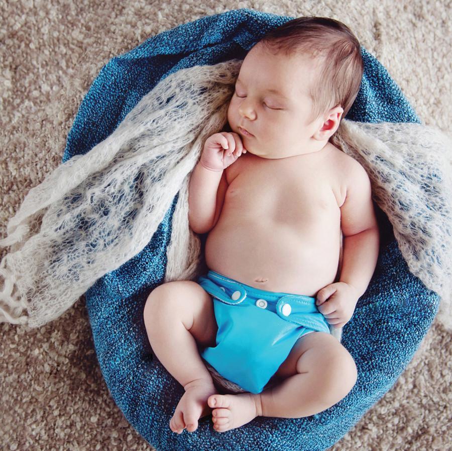 Baby in turquiose Charlie Banana Reusable Cloth Diaper